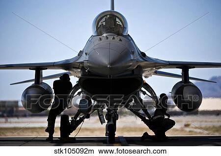 U. S. Air Force crew chiefs do pre-flight checks under an F-16 Fighting Falcon. View Large Photo Image Picture - U. S. Air Force crew chiefs do pre-flight checks under an F-16 Fighting Falcon.. Fotosearch