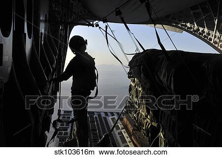 U. S. Air Force loadmaster preparing to release a container delivery system over Afghanistan. View Large Photo Image Picture - U. S. Air Force loadmaster preparing to release a container delivery system over Afghanistan. . Fotosearch