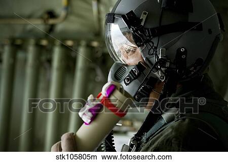 Picture - U. S. Air Force member prepares to throw a wind sonde out a C-130J Hercules.. Fotosearch