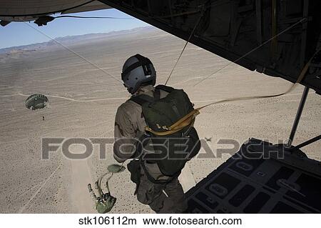 U. S. Air Force pararescuemen jump from a C-130 Hercules. View Large Photo Image Picture - U. S. Air Force pararescuemen jump from a C-130 Hercules.. Fotosearch