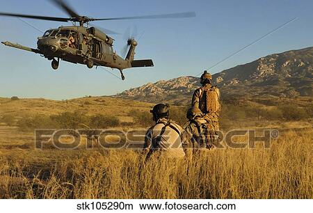 U. S. Air Force pararescuemen signal in a HH-60 Pave Hawk for extraction. View Large Photo Image Picture - U. S. Air Force pararescuemen signal in a HH-60 Pave Hawk for extraction.. Fotosearch