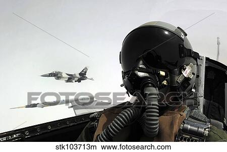 U. S. Air Force pilot takes a self-portrait with an F-16 Aggressor aircraft in the background. View Large Photo Image Picture - U. S. Air Force pilot takes a self-portrait with an F-16 Aggressor aircraft in the background.. Fotosearch