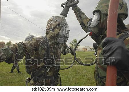 U. S. Air Force Soldier decontaminates an Airman. View Large Photo Image Picture - U. S. Air Force Soldier decontaminates an Airman.. Fotosearch