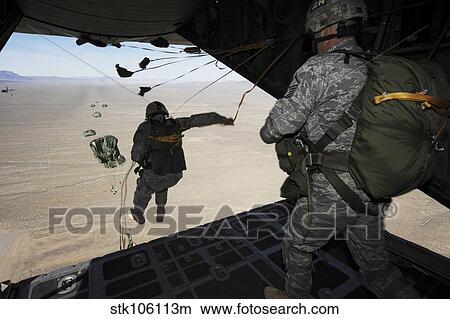 U. S. Airmen jump from a C-130 Hercules aircraft over Nevada. View Large Photo Image Picture - U. S. Airmen jump from a C-130 Hercules aircraft over Nevada.. Fotosearch