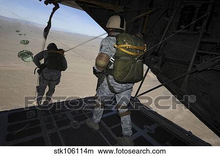 U. S. Airmen jump from a C-130 Hercules aircraft over Nevada. View Large Photo Image Picture - U. S. Airmen jump from a C-130 Hercules aircraft over Nevada.. Fotosearch