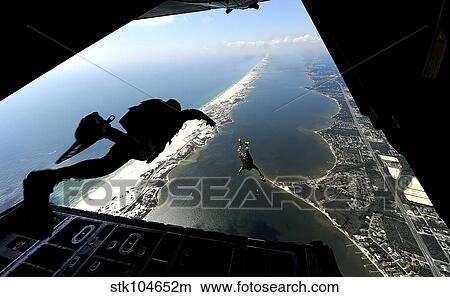 Picture - U. S. Airmen jump out of a C-130 Hercules.. Fotosearch