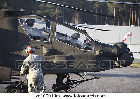 U. S. Army AH-64D Apache helicopter pilots conduct preflight checks. View Large Photo Image Picture - U. S. Army AH-64D Apache helicopter pilots conduct preflight checks.. Fotosearch