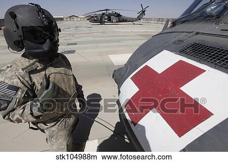 U. S. Army crew chief inspects the exterior of a UH-60 Black Hawk. View Large Photo Image Picture - U. S. Army crew chief inspects the exterior of a UH-60 Black Hawk.. Fotosearch