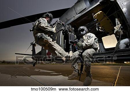 U. S. Army crew strapped into the medevac hoist of a UH-60L Black Hawk. View Large Photo Image Picture - U. S. Army crew strapped into the medevac hoist of a UH-60L Black Hawk.. Fotosearch