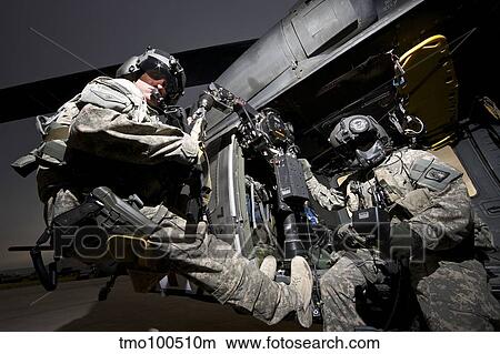 U. S. Army crew strapped into the medevac hoist of a UH-60L Black Hawk. View Large Photo Image Picture - U. S. Army crew strapped into the medevac hoist of a UH-60L Black Hawk.. Fotosearch