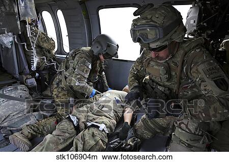 U. S. Army flight medics aid a simulated casulaty in a UH-60 Black Hawk. View Large Photo Image Picture - U. S. Army flight medics aid a simulated casulaty in a UH-60 Black Hawk.. Fotosearch