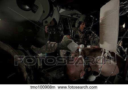 U. S. Army medics simulating ventilation of a mock patient aboard a UH-60 Blackhawk. View Large Photo Image Picture - U. S. Army medics simulating ventilation of a mock patient aboard a UH-60 Blackhawk.. Fotosearch