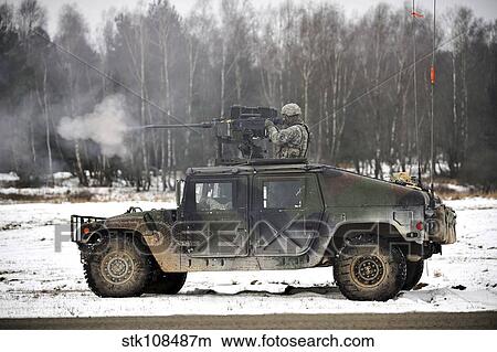 Picture - U. S. Army paratrooper fires an M2. 50-caliber machine gun atop a humvee.. Fotosearch