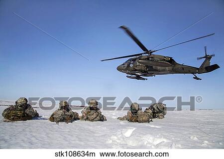 U. S. Army paratroopers pull security after exiting a UH-60 Black Hawk. View Large Photo Image Picture - U. S. Army paratroopers pull security after exiting a UH-60 Black Hawk.. Fotosearch