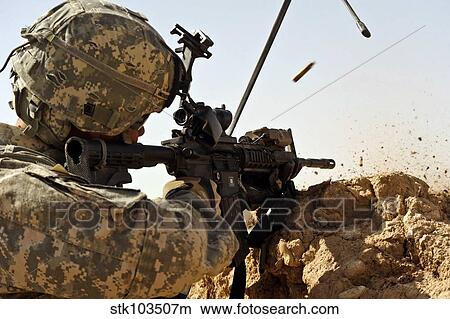 U. S. Army soldier engages enemy forces in a small arms fire fight in Afghanistan. View Large Photo Image Picture - U. S. Army soldier engages enemy forces in a small arms fire fight in Afghanistan.. Fotosearch