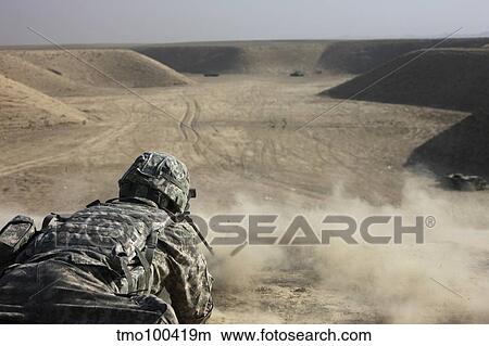 Picture - U. S. Army soldier fires a Barrett M82A1 rifle on a firing range.. Fotosearch