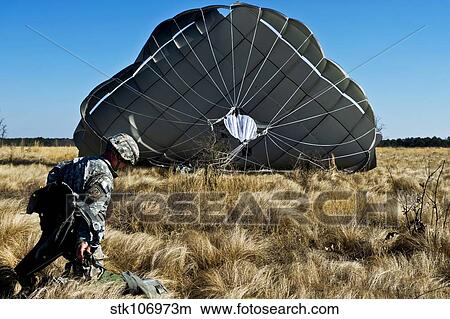 U. S. Army soldier lands after a static line airdrop. View Large Photo Image Picture - U. S. Army soldier lands after a static line airdrop.. Fotosearch