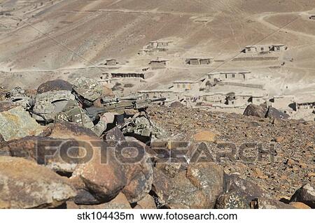 Picture - U. S. Army soldier provides security for infantry patrolling through Dandarh village, Afghanistan.. Fotosearch