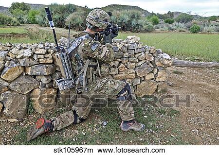 Picture - U. S. Army soldier provides security during a patrol in Afghanistan.. Fotosearch