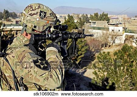 U. S. Army soldier scans for security threats from the rooftop. View Large Photo Image Picture - U. S. Army soldier scans for security threats from the rooftop.. Fotosearch