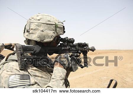 U. S. Army soldier scans the horizon through the scope of a M4 carbine. View Large Photo Image Picture - U. S. Army soldier scans the horizon through the scope of a M4 carbine.. Fotosearch