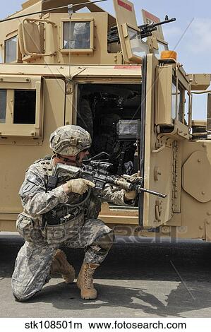 U. S. Army Soldier shouts to a fellow soldier inside a humvee. View Large Photo Image Picture - U. S. Army Soldier shouts to a fellow soldier inside a humvee.. Fotosearch