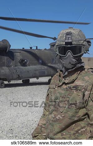 U. S. Army soldier stands ready to load a CH-47 Chinook helicopter. View Large Photo Image Picture - U. S. Army soldier stands ready to load a CH-47 Chinook helicopter.. Fotosearch