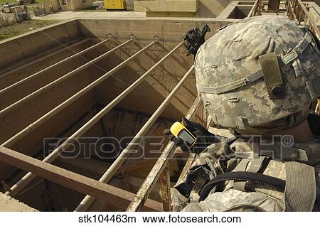 U. S. Army soldier takes a GPS grid reading at a water treatment plant. View Large Photo Image Picture - U. S. Army soldier takes a GPS grid reading at a water treatment plant.. Fotosearch