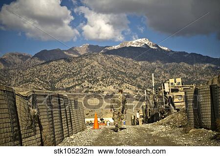 U. S. Army soldier walks down a path at Combat Outpost Herrera. View Large Photo Image Picture - U. S. Army soldier walks down a path at Combat Outpost Herrera.. Fotosearch