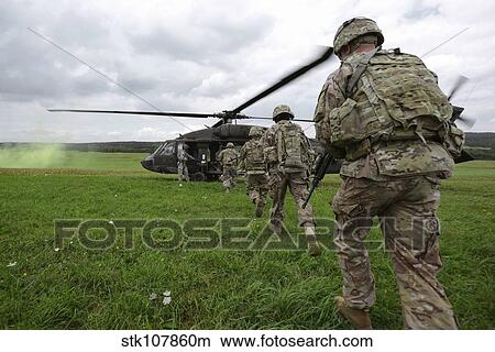 U. S. Army soldiers board a UH-60 Black Hawk helicopter. View Large Photo Image Picture - U. S. Army soldiers board a UH-60 Black Hawk helicopter.. Fotosearch