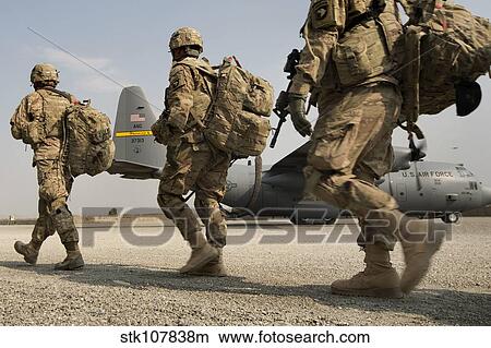 U. S. Army soldiers make their way to a C-130 Hercules. View Large Photo Image Picture - U. S. Army soldiers make their way to a C-130 Hercules.. Fotosearch