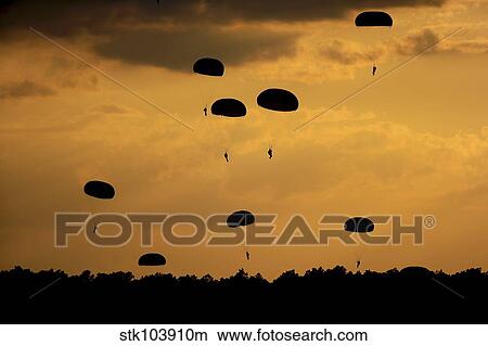 U. S. Army Soldiers parachute through the sky. View Large Photo Image Picture - U. S. Army Soldiers parachute through the sky.. Fotosearch