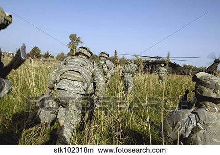 U. S. Army Soldiers prepare to board a UH-60 Black Hawk helicopter. View Large Photo Image Picture - U. S. Army Soldiers prepare to board a UH-60 Black Hawk helicopter.. Fotosearch