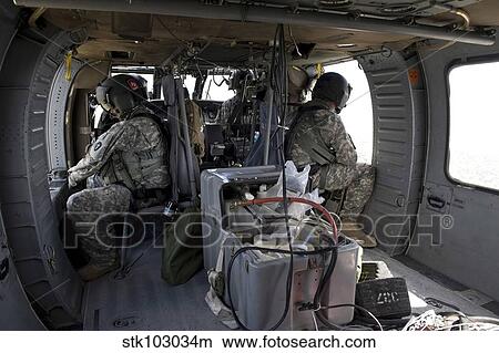 U. S. Army soldiers watch for hazards during a flight to provide air support. View Large Photo Image Picture - U. S. Army soldiers watch for hazards during a flight to provide air support.. Fotosearch