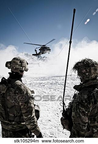 U. S. Army soldiers watch the arrival of a helicopter at an outpost in Afghanistan. View Large Photo Image Picture - U. S. Army soldiers watch the arrival of a helicopter at an outpost in Afghanistan.. Fotosearch
