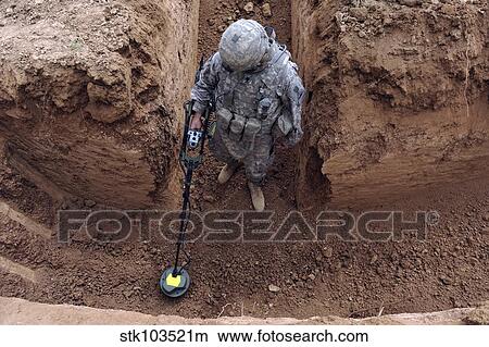 U. S. Army Specialist searches for a weapons cache in Kirkuk, Iraq. View Large Photo Image Picture - U. S. Army Specialist searches for a weapons cache in Kirkuk, Iraq.. Fotosearch