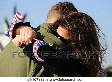U. S. aviator embraces his wife during the squadron's homecoming. View Large Photo Image Picture - U. S. aviator embraces his wife during the squadron's homecoming.. Fotosearch
