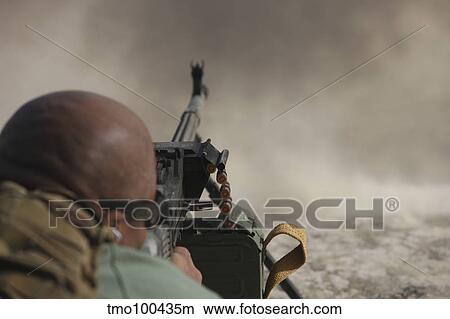 U. S. Contractor firing the PKM 7. 62 machine gun. View Large Photo Image Picture - U. S. Contractor firing the PKM 7. 62 machine gun.. Fotosearch