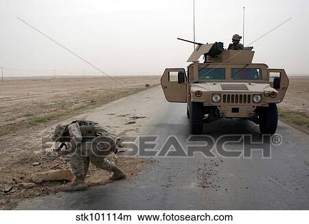 U. S. Marine checks a pothole for mines. View Large Photo Image Picture - U. S. Marine checks a pothole for mines.. Fotosearch