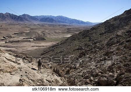 U. S. Marine climbs a hill to conduct a site survey in Afghanistan. View Large Photo Image Picture - U. S. Marine climbs a hill to conduct a site survey in Afghanistan.. Fotosearch