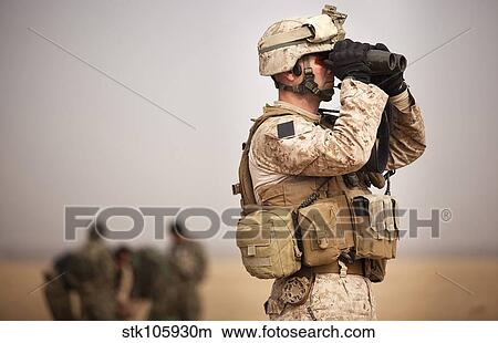 U. S. Marine determines target placement at a target range in Afghanistan. View Large Photo Image Picture - U. S. Marine determines target placement at a target range in Afghanistan.. Fotosearch