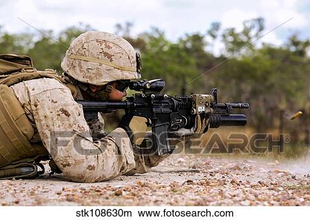 U. S. Marine fires rounds down range during a live fire exercise. View Large Photo Image Picture - U. S. Marine fires rounds down range during a live fire exercise.. Fotosearch
