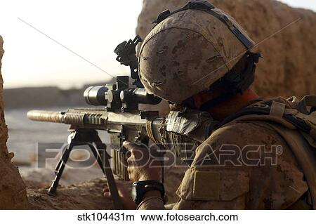 U. S. Marine looks through the scope of his M16A4 rifle for enemy forces. View Large Photo Image Picture - U. S. Marine looks through the scope of his M16A4 rifle for enemy forces.. Fotosearch