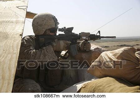 Picture - U. S. Marine mans a security post during a mission in Afghanistan.. Fotosearch