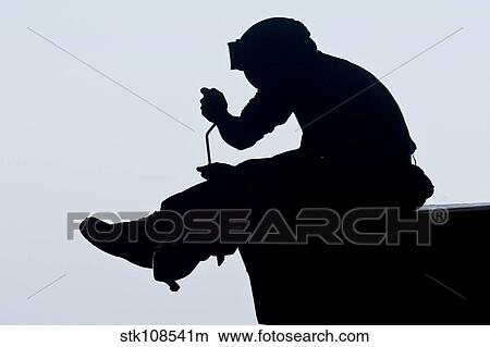 Picture - U. S. Marine performs maintenance on the missile panel of an F/A-18C Hornet.. Fotosearch