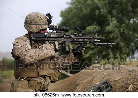 Picture - U. S. Marine provides security with an M249 Squad Automatic Weapon.. Fotosearch