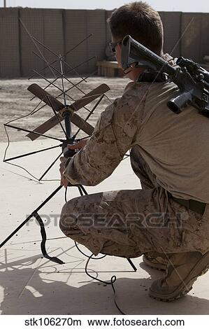 U. S. Marine repositions a satellite communication antenna. View Large Photo Image Picture - U. S. Marine repositions a satellite communication antenna.. Fotosearch