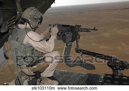 U. S. Marine test firing an M240 heavy machine gun on the back of a MV-22B Osprey. View Large Photo Image Picture - U. S. Marine test firing an M240 heavy machine gun on the back of a MV-22B Osprey.. Fotosearch