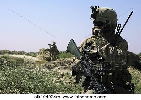 U. S. Marine uses a radio during a security patrol in Afghanistan. View Large Photo Image Picture - U. S. Marine uses a radio during a security patrol in Afghanistan.. Fotosearch