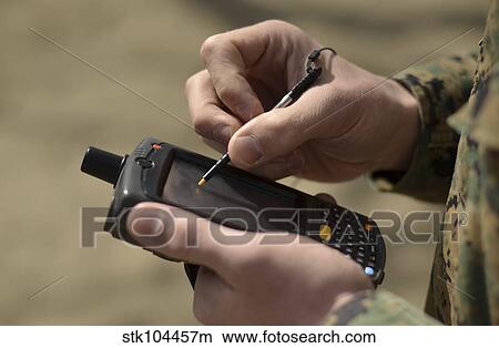U. S. Marine using GPS capabilities on a handheld device to check his location. View Large Photo Image Picture - U. S. Marine using GPS capabilities on a handheld device to check his location.. Fotosearch